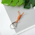 Vibrant orange braided rope keychain with silver metal carabiner on a modern background - Orange + Round Buckle + Triangle Spring Ring