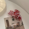 Detailed close-up of a large pink floral acetate hair claw clip with marble texture - Dragon Bone Claw / Blood Red