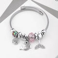 Silver charm bracelet with dolphin, crown and pink crystal beads on white background - C1-016 Pink