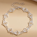 Macro detail of silver-tone hollow heart chain bracelet with high-gloss metal finish - Silver