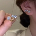 Elegant tulip pearl stud earrings with zircon in gold finish worn by a woman - Pearl Zirconia Gold