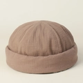 Detail of a brown cotton brimless docker hat with natural wrinkled fabric texture - Khaki