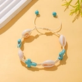 Detail of adjustable woven beach bracelet with natural shells and turquoise cross beads - Turquoise Cross Woven Style