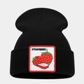 Close-up of black knitted beanie featuring a white patch with embroidered red strawberries - Strawberry Pattern
