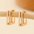 Macro shot of gold-plated rectangular earrings with pavé cubic zirconia on wood - EH222 Rectangular Single Pave
