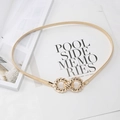 Detail of golden elastic waist belt with interlocking double ring metal buckle on magazine - Gold Round Buckle Spring Chain