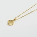 Minimalist gold necklace with a letter Q pendant showing honeycomb texture detail on back - Letter Q