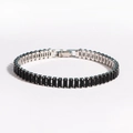 Close-up of black rectangular zircon stones set in a polished silver chain bracelet - Platinum Plated Black Zirconia