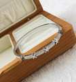 Silver stainless steel narrow bangle featuring star patterns and inlaid gemstones - Steel