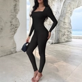 Slim fit black long sleeve ribbed yoga jumpsuit with square neck shown on scenic background - S / Black