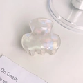Elegant mini pearlescent hair claw clip with aurora iridescent finish on white desk - 3.5cm / AB White