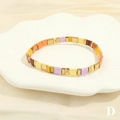 Detail of colorful Tila beaded bracelet in vintage bohemian style on shell dish - Vintage Orange & Purple Set