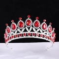 Baroque bridal crown with red pear-shaped crystals and silver filigree on a black background - Silver With Red
