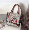 Detail of owl embroidery and 'Love to the Moon' text on a thick canvas tote bag - Letter Green Owl