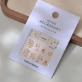 Star and moon nail art charms set with blue rhinestones and gold accents on MJ-046 card - Star Moon Blue Rhinestone Style (MJ-046) / Foil Stamping
