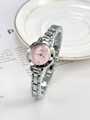 Macro detail of a small silver watch with a pink dial and elegant Roman numeral markers - Silver Pink