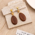 Macro view of geometric wooden drop earrings with natural wood grain and cream bead - E5430 (Waterdrop Patchwork)