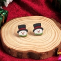 Festive snowman stud earrings in white and red colors on a natural wooden display base - Snowman
