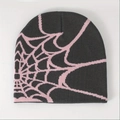 Close-up of spider web jacquard pattern on dark grey and pink knitted beanie hat - Gray