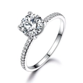 Elegant 925 sterling silver ring featuring a round brilliant cut diamond in a four-prong setting - Size 5 / Round White Zirconia Row Style (RUJ065Z-1)