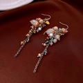 Detailed view of vintage flower tassel earrings with orange beads on brown satin fabric - 25# Ear Hook - Silver - Multi-color Beaded - Vintage Long Tassel