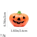 Detailed view of 3D resin Halloween pumpkin charm with black smiling face and green stem - Orange Smiling Pumpkin