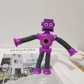 Robot pop tube viola con arti flessibili e ventose posizionato sopra una rivista - Senza Luce / Viola