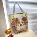 Detail of floral butterfly dog embroidery on beige canvas tote bag with striped handles - Short Eared Dog