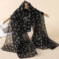 Elegant black long chiffon scarf featuring white cat silhouette print hanging on hanger - Black Cat Silhouette