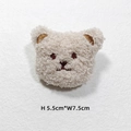 Close-up of cream plush bear accessory with embroidery, measuring 5.5cm by 7.5cm - Beige Bear