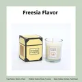 Freesia scented candle in glass jar with yellow box featuring melon and rose notes - Freesia / White