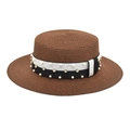 Detail of wide brim straw hat featuring black and white band with pearls and rhinestones - Coffee