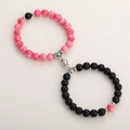 Detail of magnetic heart charm connecting pink marble and matte black beaded bracelets - Pink Stone & Frosted Black With Round Magnet