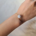 Irregular natural crystal stone bracelet with gold stainless steel chain on wrist - Aquamarine