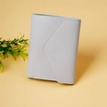 Detail of light grey tri-fold mini wallet showing pebbled texture and envelope flap design - Light Blue
