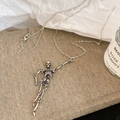 Silver skull necklace set in gothic style displayed on books with soft natural lighting - Skeleton Pendant Necklace / Silver