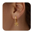 Chic 18K gold plated brass hoop earrings with a cute bow pendant shown on a model - 14k