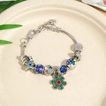 Detailed view of Christmas charm bracelet with snowflake pendant on ceramic tray - Snowflake Moon Star Silver Blue (Style 3) / 19cm