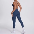Detail of dark blue yoga set showing criss-cross back sports bra and high-waisted leggings - S / Navy Blue
