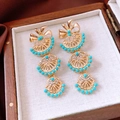 Détail de boucles d'oreilles vintage avec perles turquoise dans un coffret en bois - Style Pampille Or Bleu