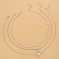 Three-layer silver necklace set with butterfly pendant and faux pearls on light background - Silver Triple Layer Artificial Pearl (5451)