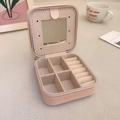 Detail view of pink macaron jewelry box with mirror, velvet lining and ring slots - Pink