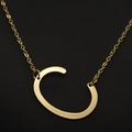 Elegant gold letter C pendant necklace with a minimalist fine chain on black background - Gold C