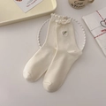 Creamy white cotton mid-calf socks with delicate ruffle trim and green floral embroidery - One Size / Flower Border / Cream