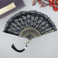 Elegant black lace folding fan with gold floral carvings and a black tassel accessory - Black with Tassel
