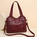 Chic burgundy tote bag with dual handles and side zippers on a clean white background - Burgundy