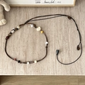 Detailed flat lay of bohemian braided waist chain with ceramic and wooden beads - Water Drop Tail Two-Tone Rope - 169cm