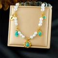 Detailed shot of turquoise charms and pearl chain on a jewelry box display - Turquoise Heart Lock Style (N3738)
