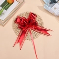 Close-up of a large red matte metallic chiffon pull bow for Christmas gift wrapping - Red