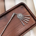 Detail view of ethnic Miao silver hair pin with fringe tassels on dark wood tray - F0742 Hair Stick-4# (Antique Silver Carved Column Tassel)